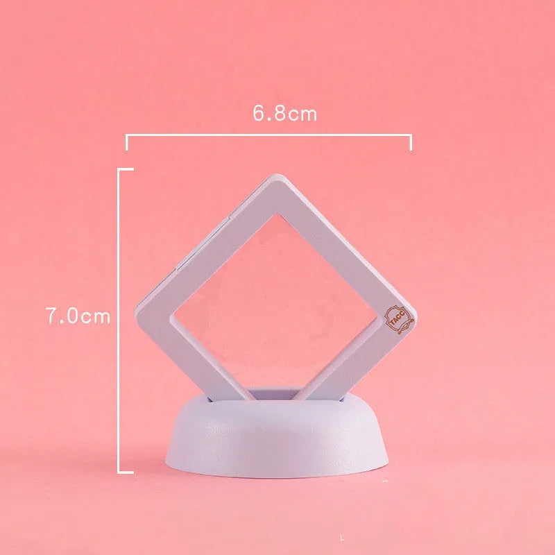 3D floating display case holding a coin suspended between transparent membrane sheets, black frame