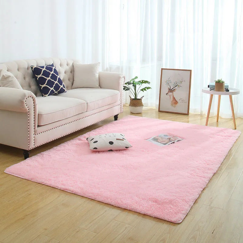 Machine woven plain rectangle fluffy rug in beige long-hair finish on a wooden floor