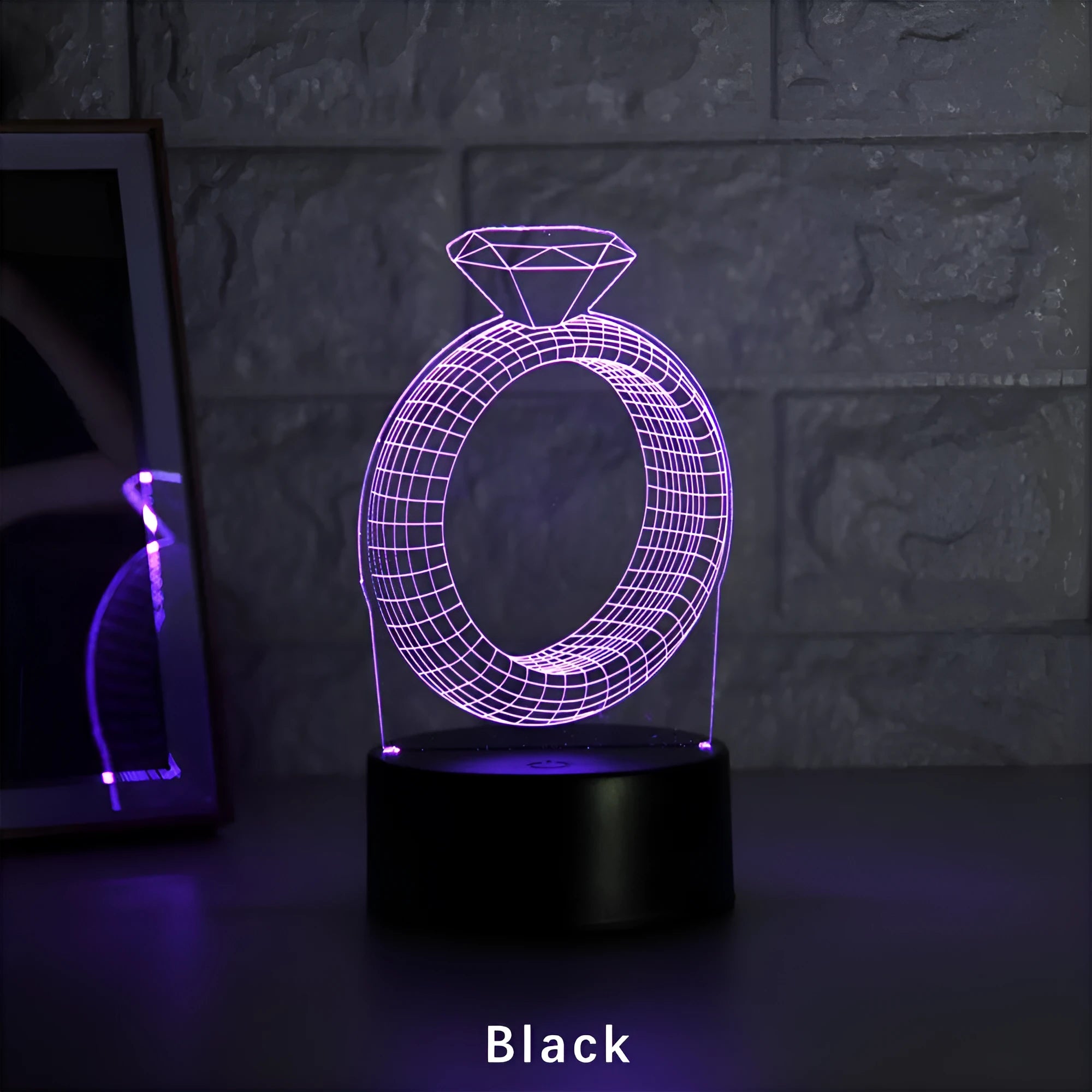 3D LED night light glowing with colour-changing light on a diamond ring laser engraving inside a black base.