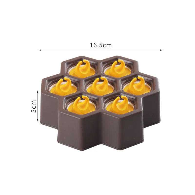 Brown plastic ice cube mould with cartoon anti-drip rim and honeycomb-shaped cavities