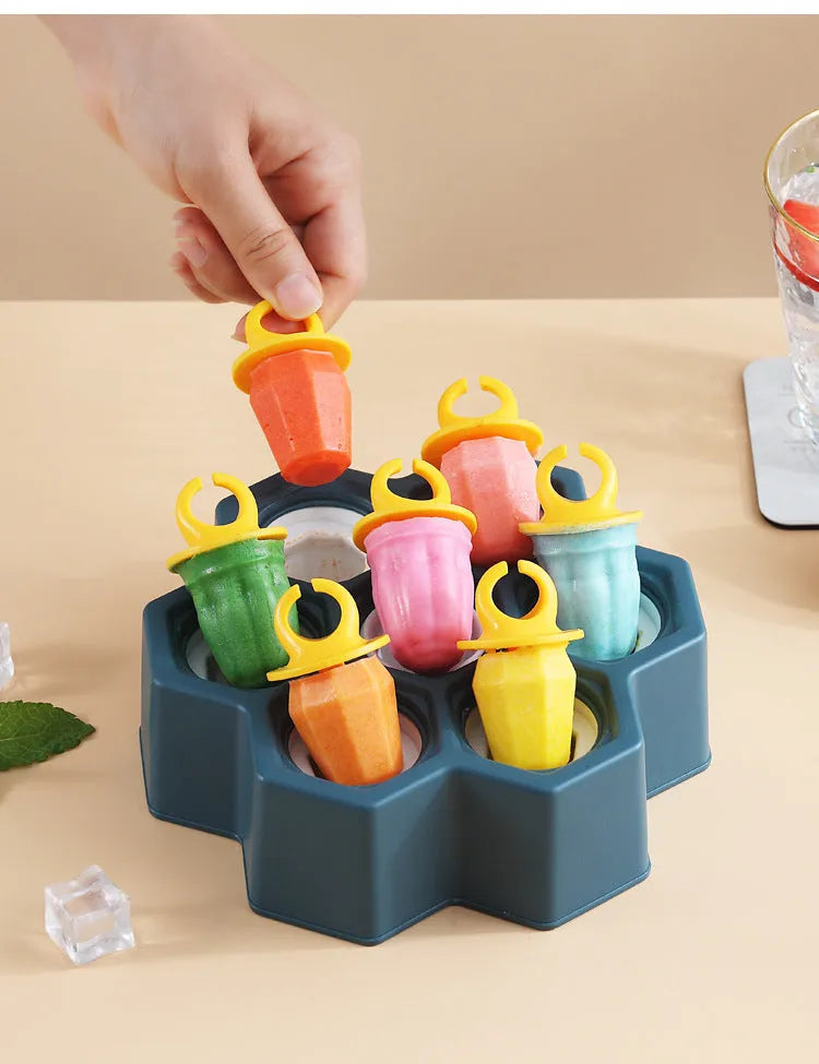 Brown plastic ice cube mould with cartoon anti-drip rim and honeycomb-shaped cavities