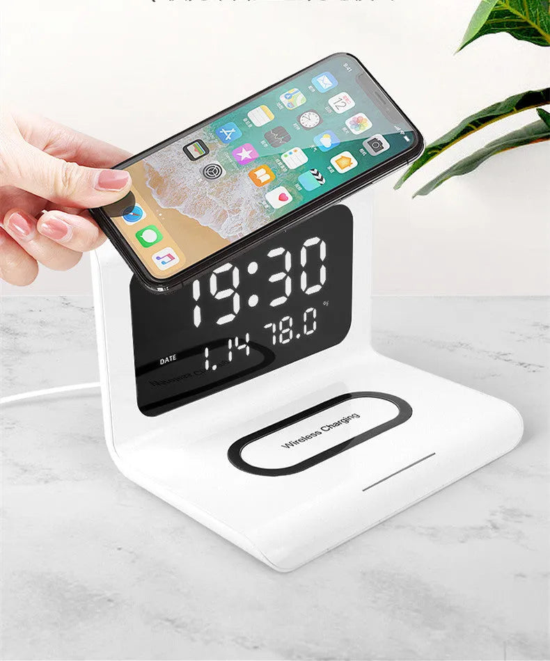 White wireless charger alarm clock showing time, date, temperature, and humidity on its display.