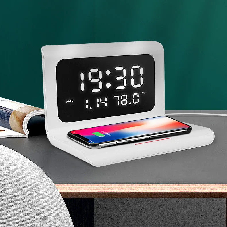 White wireless charger alarm clock showing time, date, temperature, and humidity on its display.