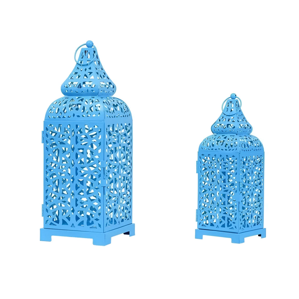 A blue hollow geometric iron candelabrum, 38cm tall, holding a candle on a wooden surface.