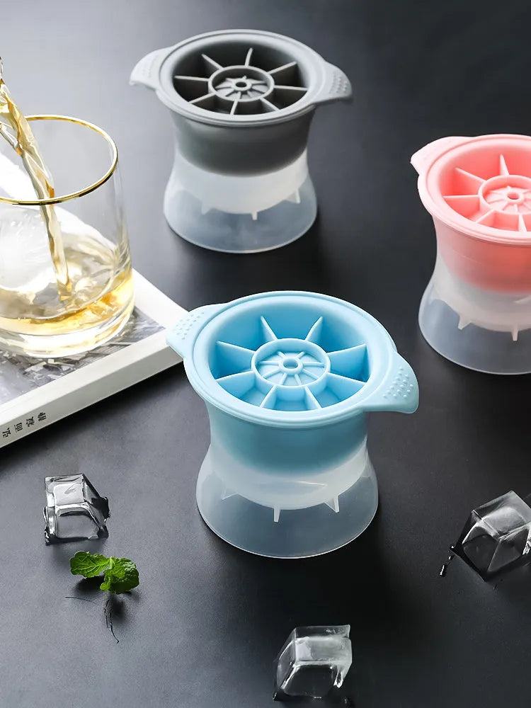 Flexible silicone ice tray showing large ice hockey, pentagon, and spherical mould designs in light blue.