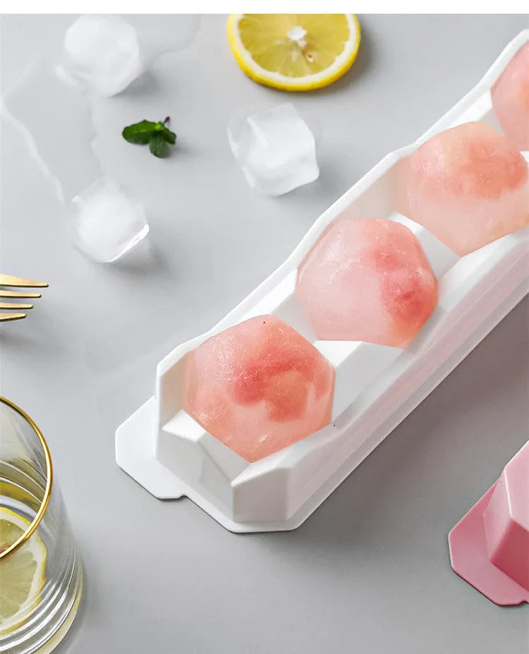 Flexible silicone ice tray showing large ice hockey, pentagon, and spherical mould designs in light blue.