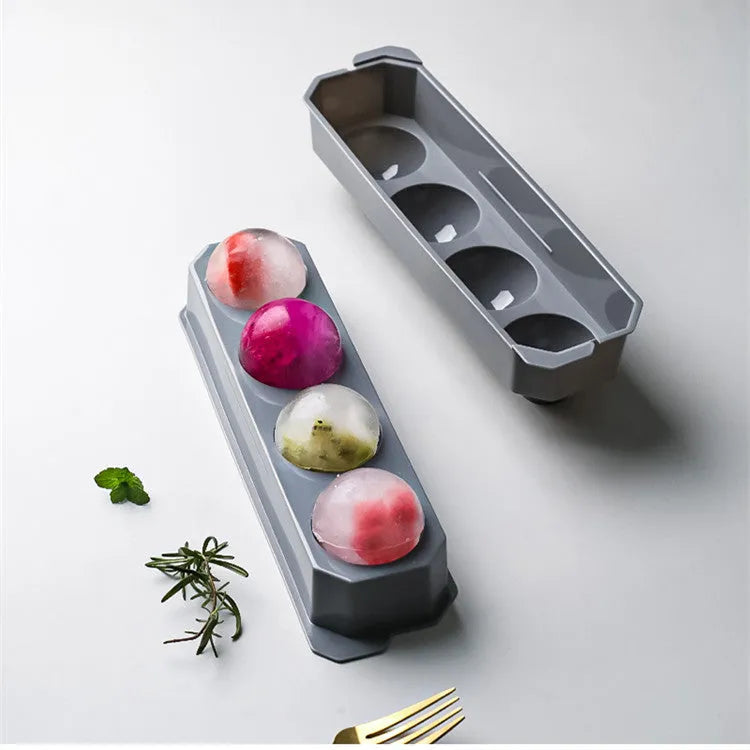 Flexible silicone ice tray showing large ice hockey, pentagon, and spherical mould designs in light blue.