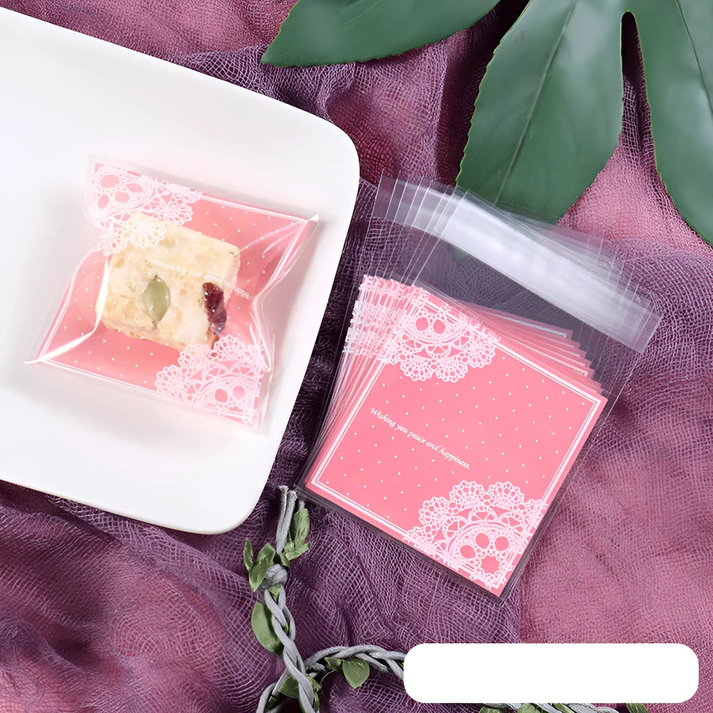 Clear self-adhesive plastic packaging bags with pink UV print, showing 7cm by 7cm size and gusset.