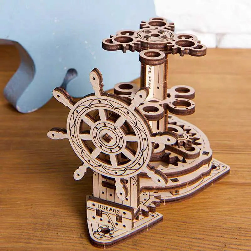 Solid wooden steering wheel pen holder with central pencil compartment on a desk