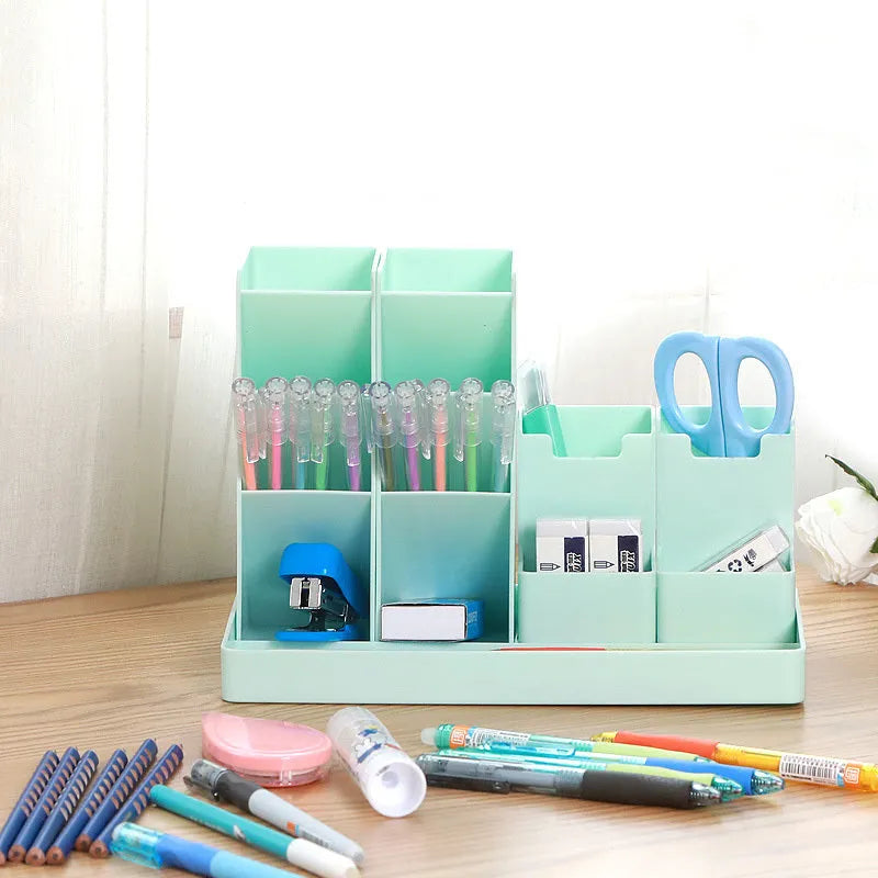 Combination pen holder in turquoise green with multiple storage grids for pens on a desk