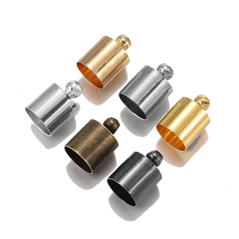 Assortment of small, bell-shaped copper caps in gold, silver, bronze, and black finishes for jewellery making.