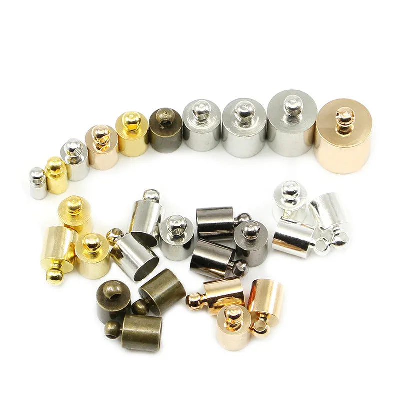 Assortment of small, bell-shaped copper caps in gold, silver, bronze, and black finishes for jewellery making.