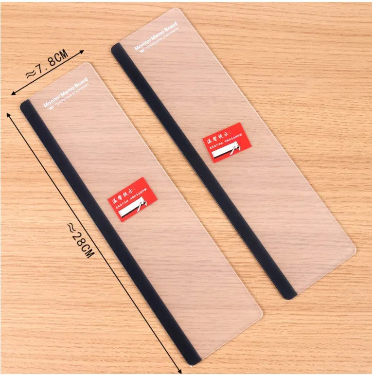 Transparent acrylic computer monitor side pane note board measuring 28cm by 7.8cm beside a screen