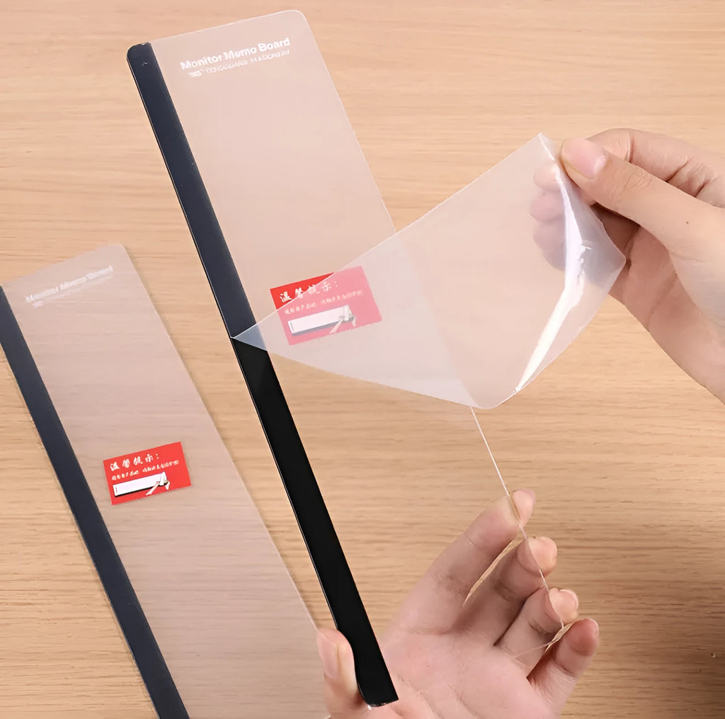 Transparent acrylic computer monitor side pane note board measuring 28cm by 7.8cm beside a screen