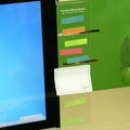 Transparent acrylic computer monitor side pane note board measuring 28cm by 7.8cm beside a screen