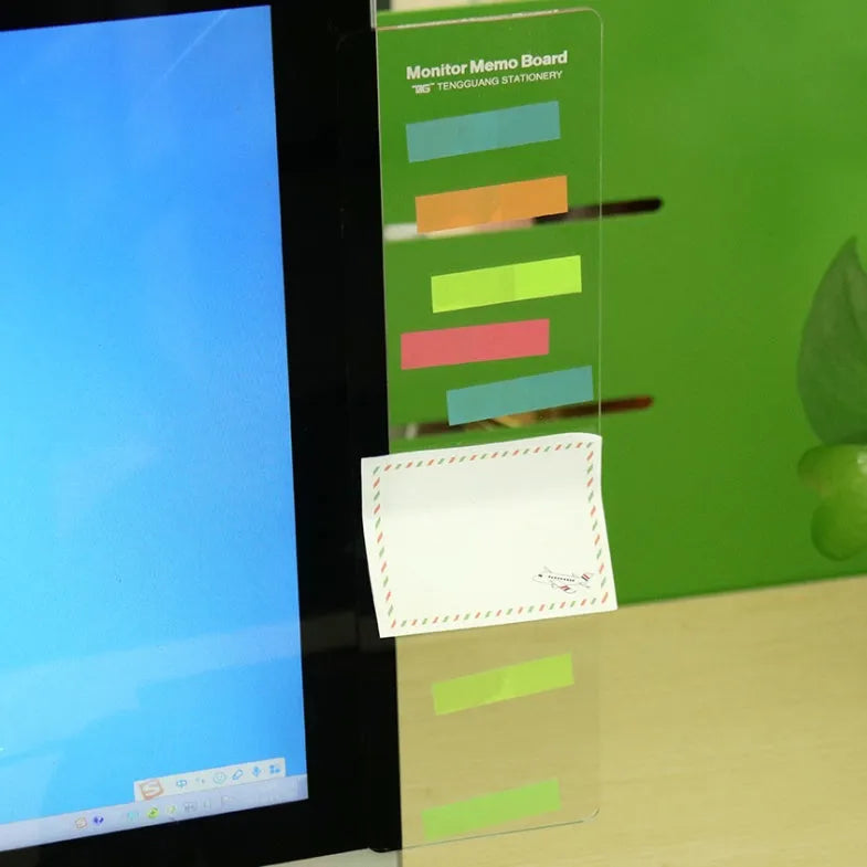 Transparent acrylic computer monitor side pane note board measuring 28cm by 7.8cm beside a screen
