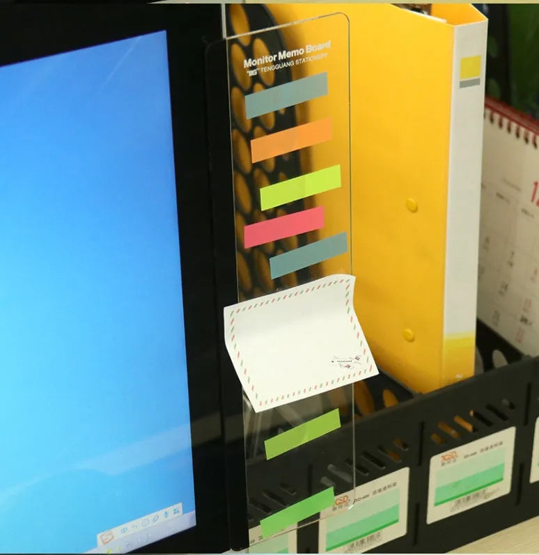 Transparent acrylic computer monitor side pane note board measuring 28cm by 7.8cm beside a screen