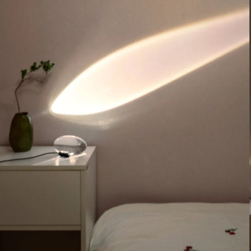 Projection lamp with crystal shade emitting warm LED light on a desk, 160x90 mm