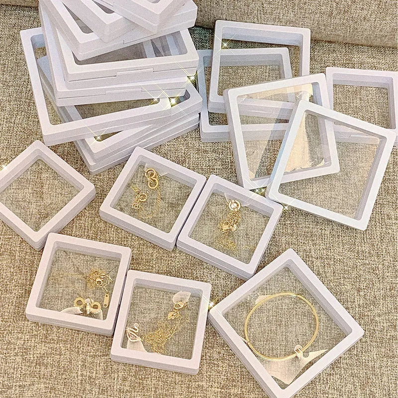 3D floating display case holding a coin suspended between transparent membrane sheets, black frame