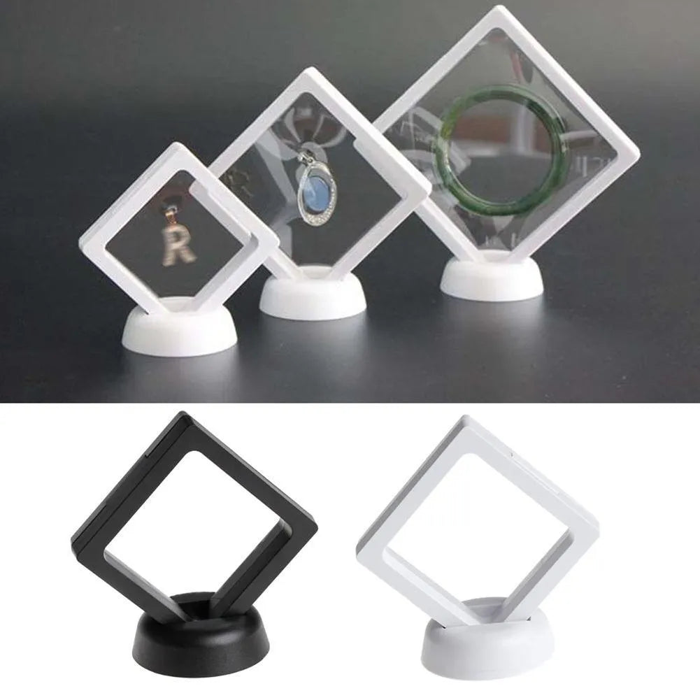 3D floating display case holding a coin suspended between transparent membrane sheets, black frame