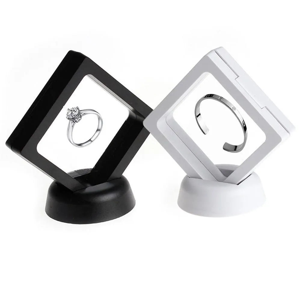 3D floating display case holding a coin suspended between transparent membrane sheets, black frame