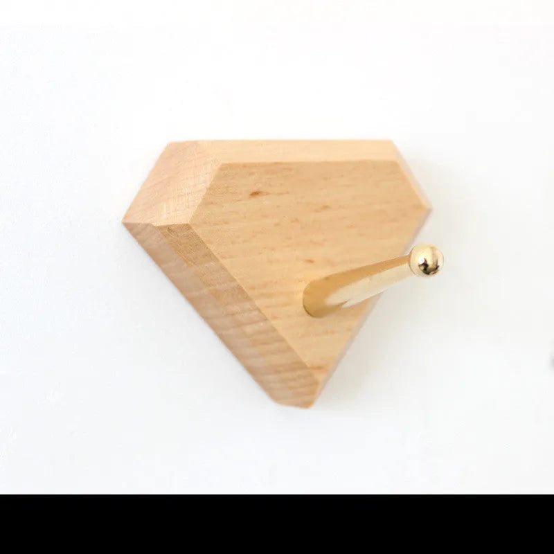 Beech wood adhesive wall hook with brass hook, shown in round, capsule, oval, diamond, and square colour options.