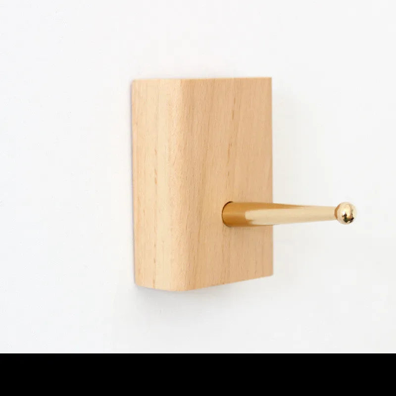Beech wood adhesive wall hook with brass hook, shown in round, capsule, oval, diamond, and square colour options.