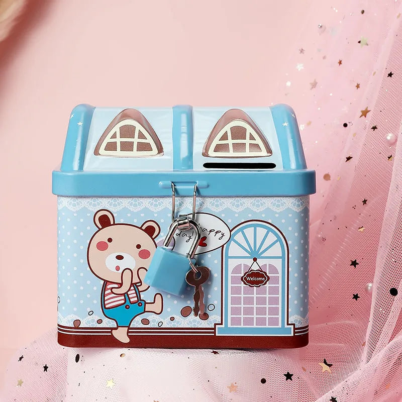 Blue house-shaped tinplate piggy bank for coin saving on desktop
