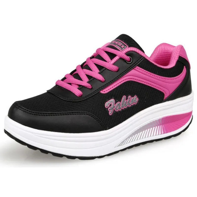 Women's grey pink mid-heel heelless sports travel shoes on a white background.