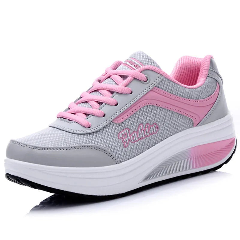 Women's grey pink mid-heel heelless sports travel shoes on a white background.