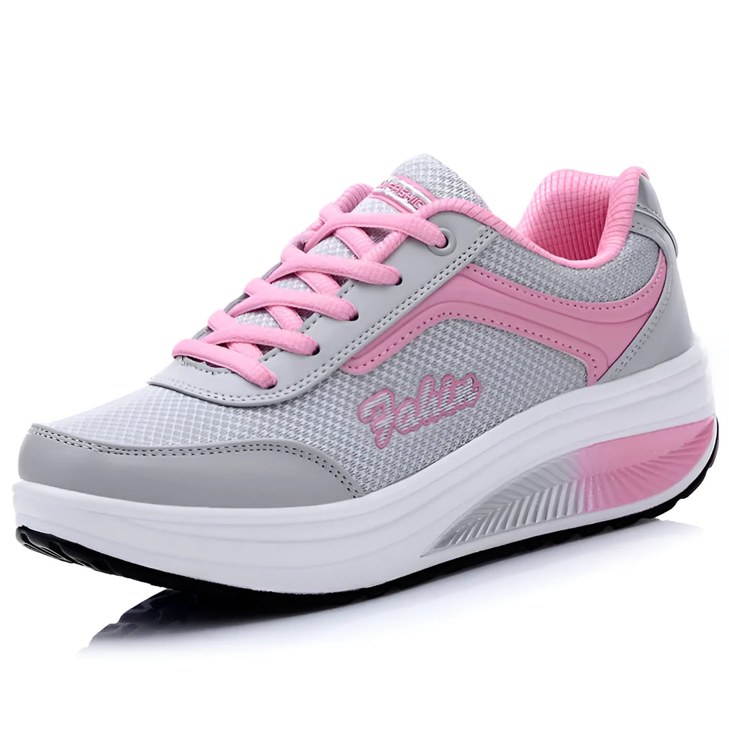 Women's grey pink mid-heel heelless sports travel shoes on a white background.