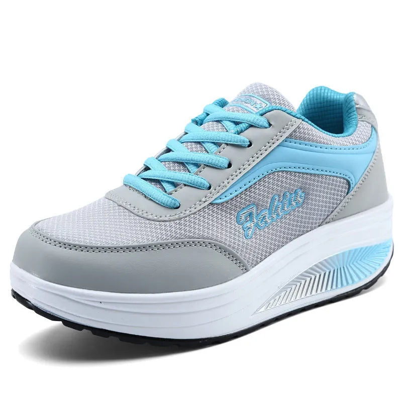 Women's grey pink mid-heel heelless sports travel shoes on a white background.