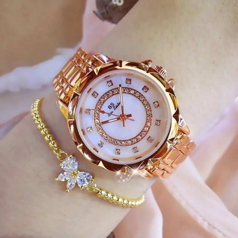 Women's quartz watch with 32mm round dial, alloy case, and mineral glass in a choice of gold or silver finishes