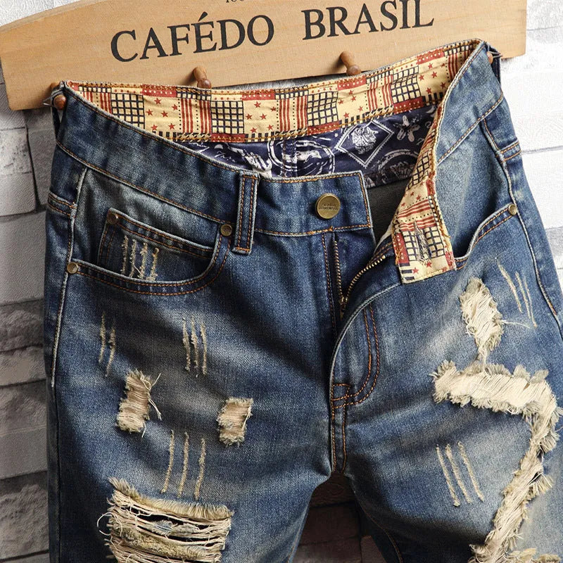 Men's big hole distressed denim Capri shorts in blue with straight leg and mid-rise waist