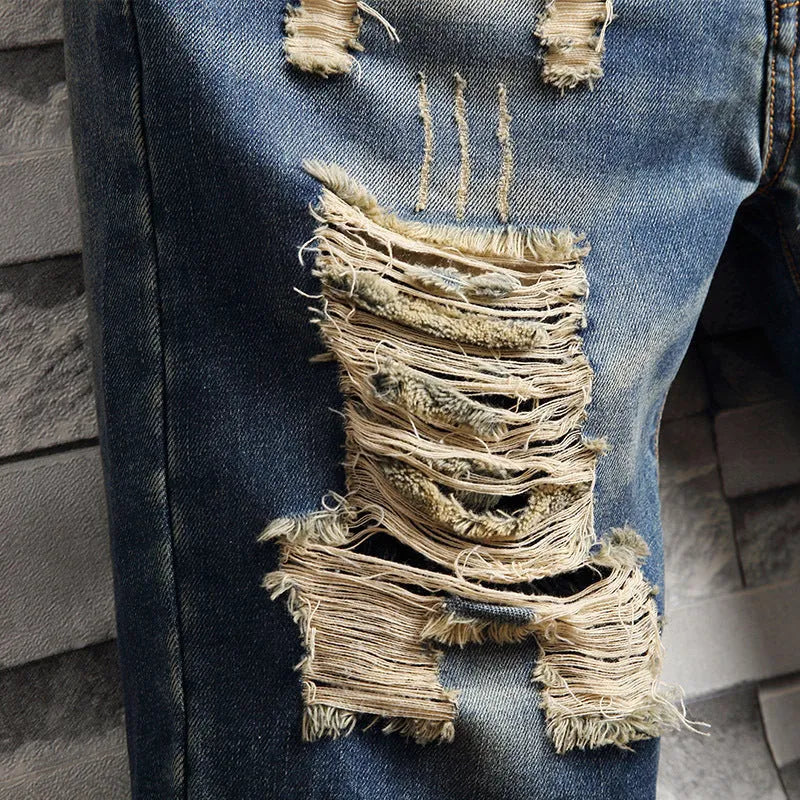 Men's big hole distressed denim Capri shorts in blue with straight leg and mid-rise waist