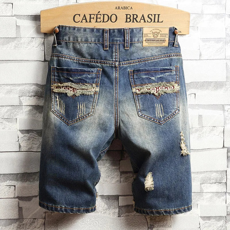 Men's big hole distressed denim Capri shorts in blue with straight leg and mid-rise waist