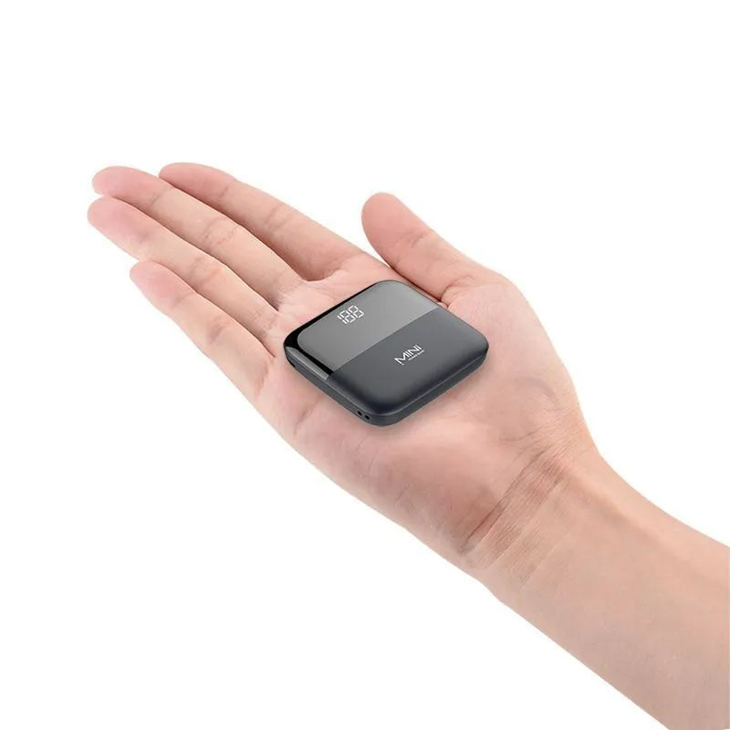 Compact digital display power bank with LCD screen showing battery level, in black plastic casing