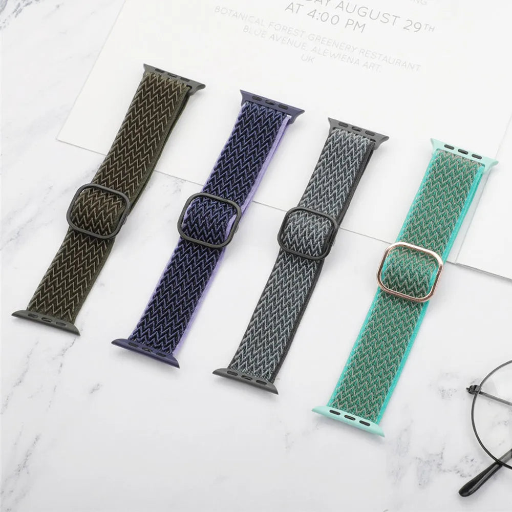 Braided elastic nylon Apple Watch strap in multiple colours on a grey background.