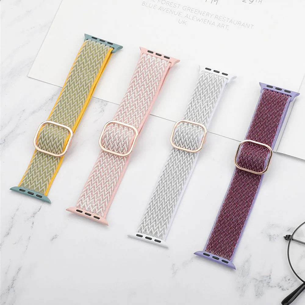 Braided elastic nylon Apple Watch strap in multiple colours on a grey background.