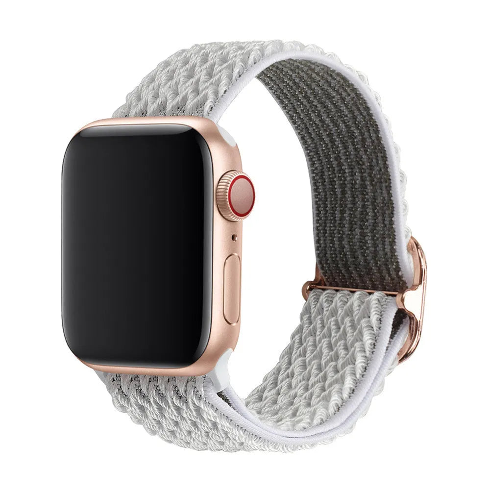 Braided elastic nylon Apple Watch strap in multiple colours on a grey background.