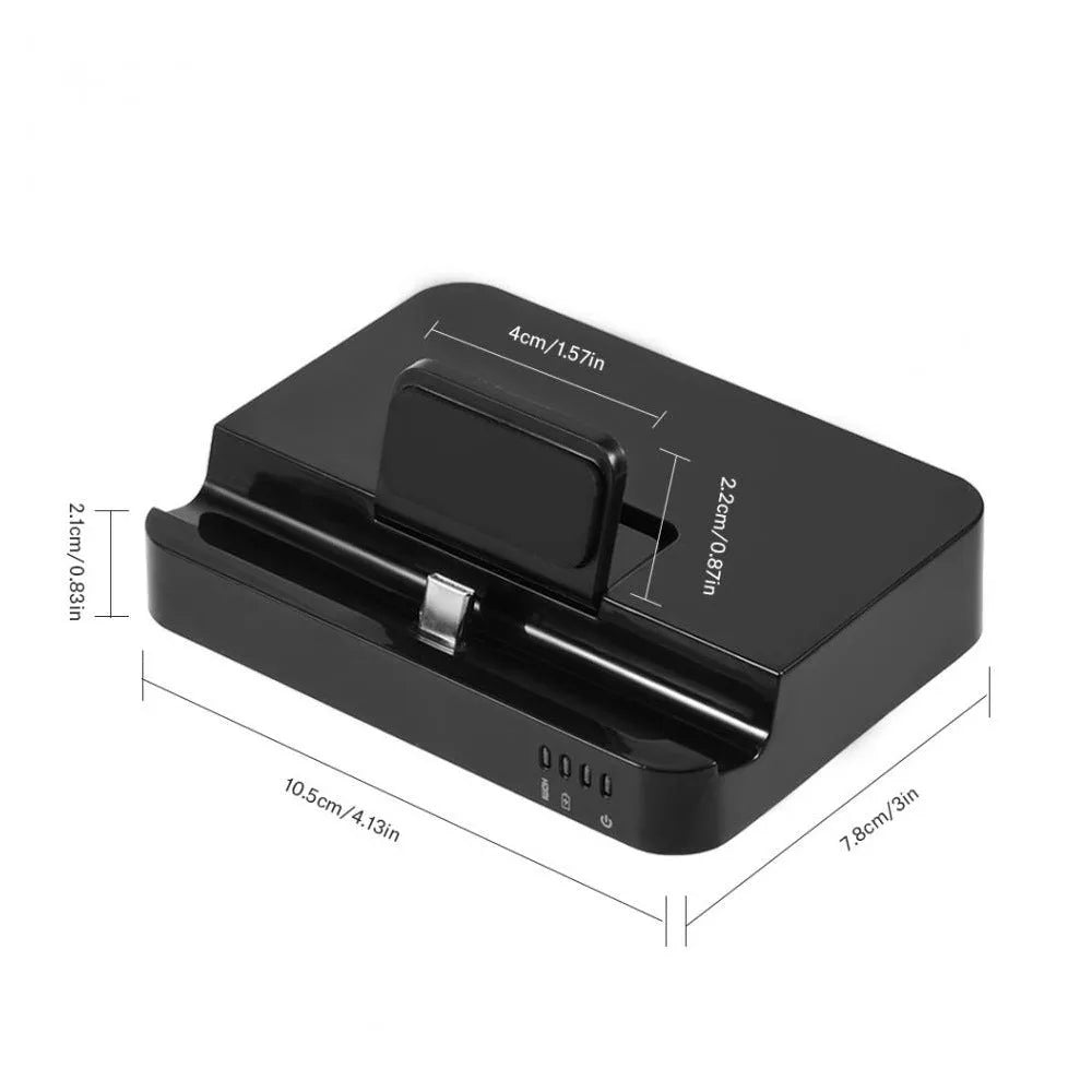 Black mobile phone to HD video converter dock on a wooden table, showing compact size and single black base design.