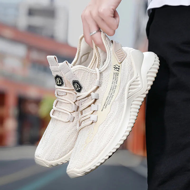 Men's white low-top lace-up trainers with mesh upper and rubber sole on a plain background.