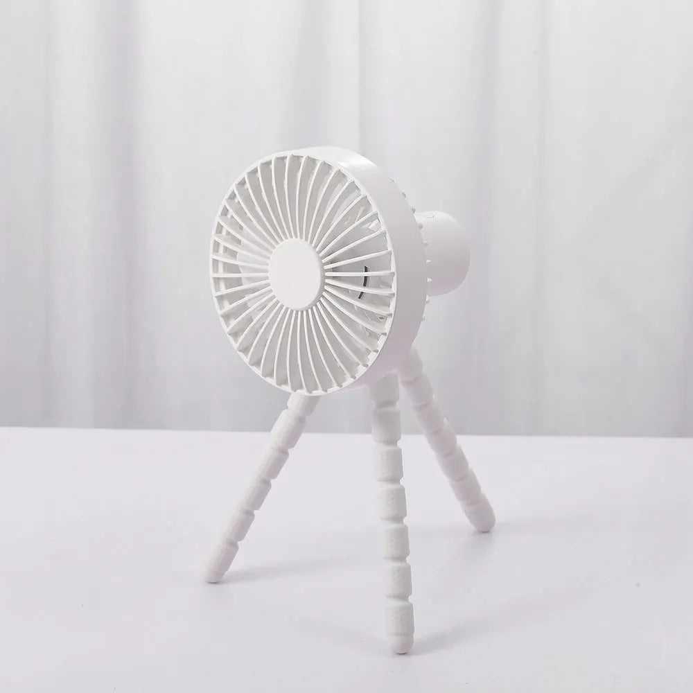 A small white USB desktop fan with an adjustable bending head on black octopus tripod legs.