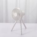 A small white USB desktop fan with an adjustable bending head on black octopus tripod legs.