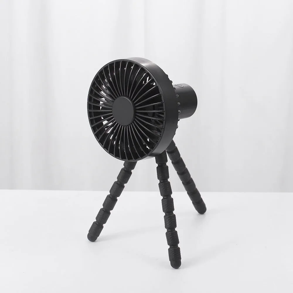 A small white USB desktop fan with an adjustable bending head on black octopus tripod legs.
