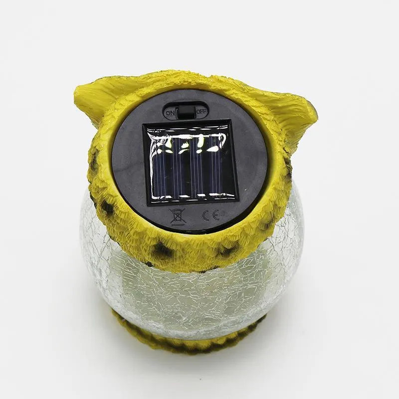 White solar owl garden light with LED illumination for outdoor pathways