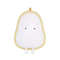 White silicone pear-shaped bedside night light emitting a warm yellow glow on a wooden table.