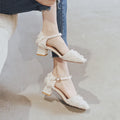Women's apricot suede D'Orsay flats with an ankle strap and a 3cm low block heel on a wooden floor.