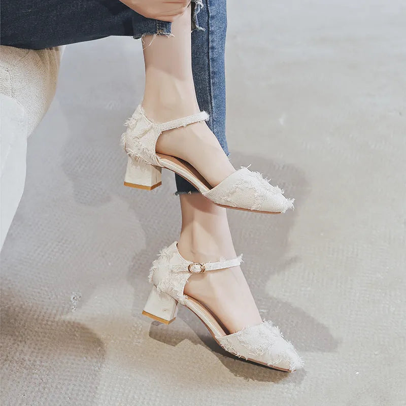 Women's apricot suede D'Orsay flats with an ankle strap and a 3cm low block heel on a wooden floor.