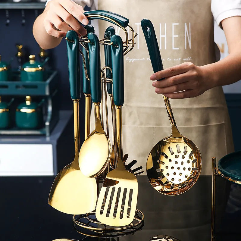 7-piece stainless steel kitchen utensil set with silicone handles showing slotted spatula, turner, ladle, serving spoon, and pasta server
